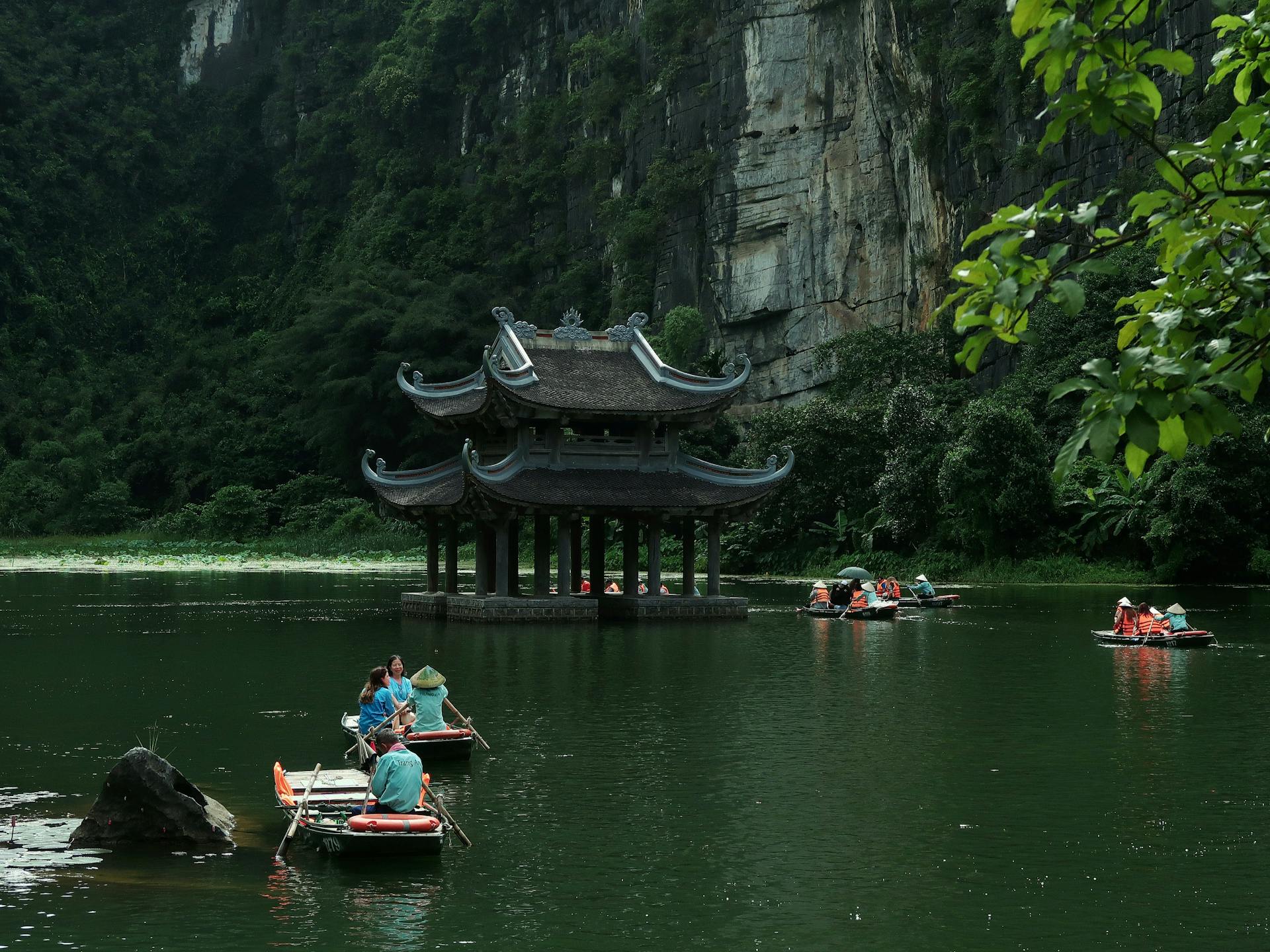 A boat gliding through the karst valleys of Ninh Binh