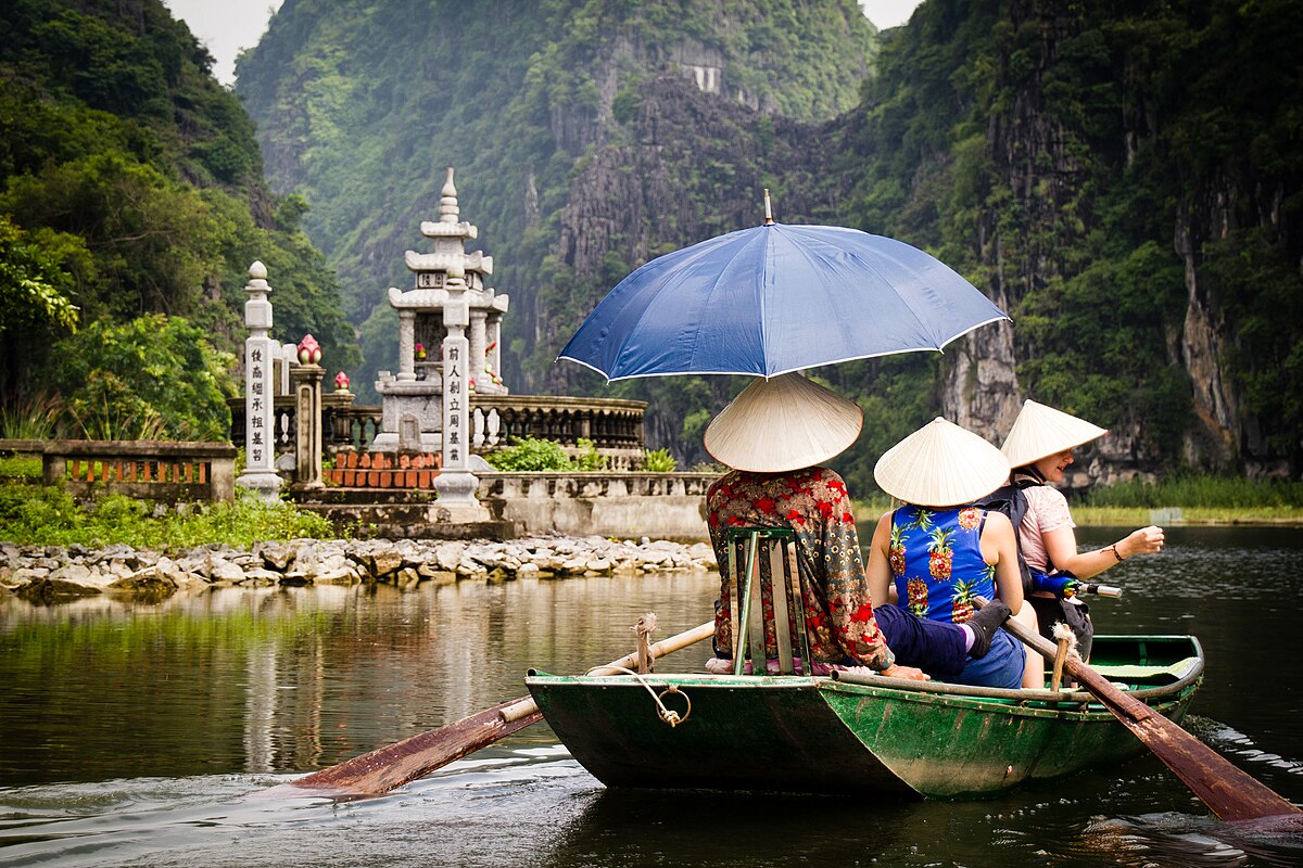 The Tam Coc boat tour winding through rice fields and karst